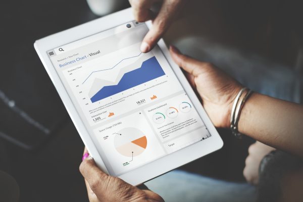 Hands Using Tablet Screen Showing Statistics Business Data Hands Using Tablet Screen Showing Statistics Business Data